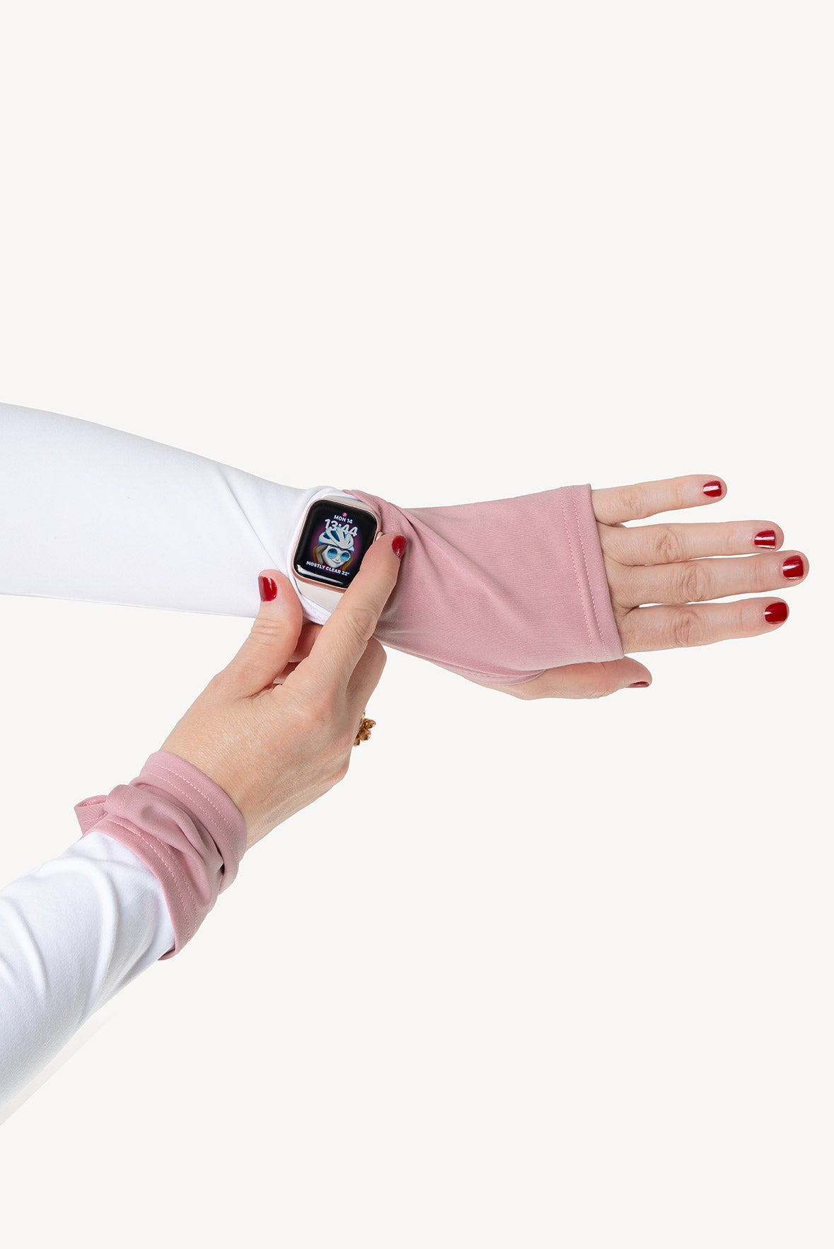 Hand wearing a pink arm warmer sleeve with a white background