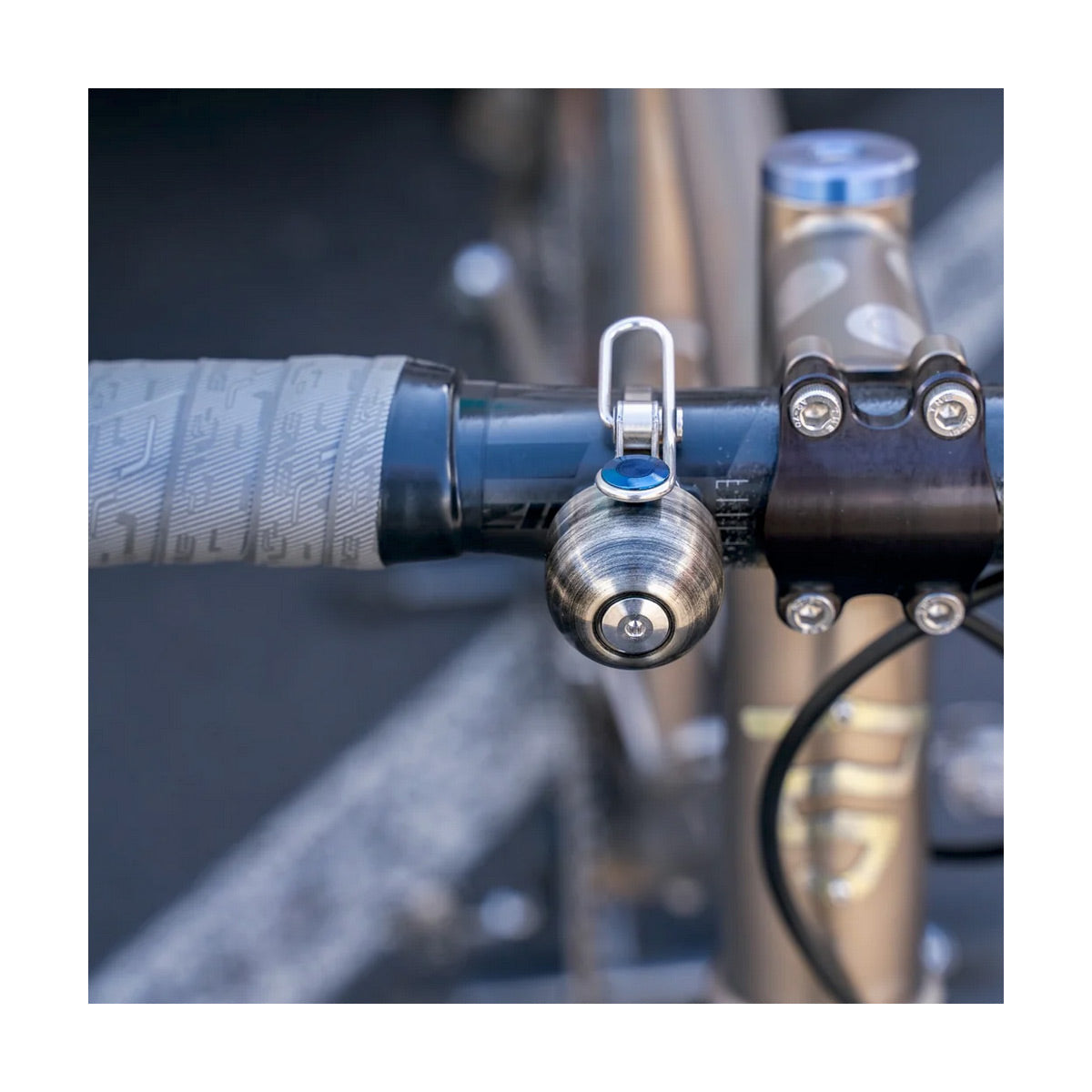 Close-up of a bicycle handlebar with a bike bell attached
