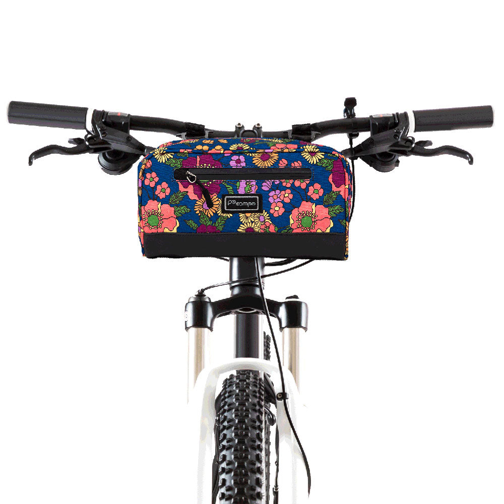 Floral-patterned bike bag attached to a bicycle handlebar on a white background