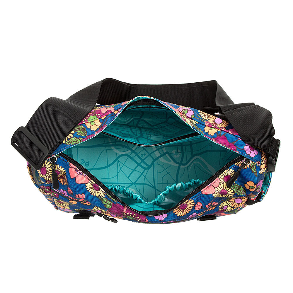Colorful floral-patterned bag shows inside with black straps on a white background