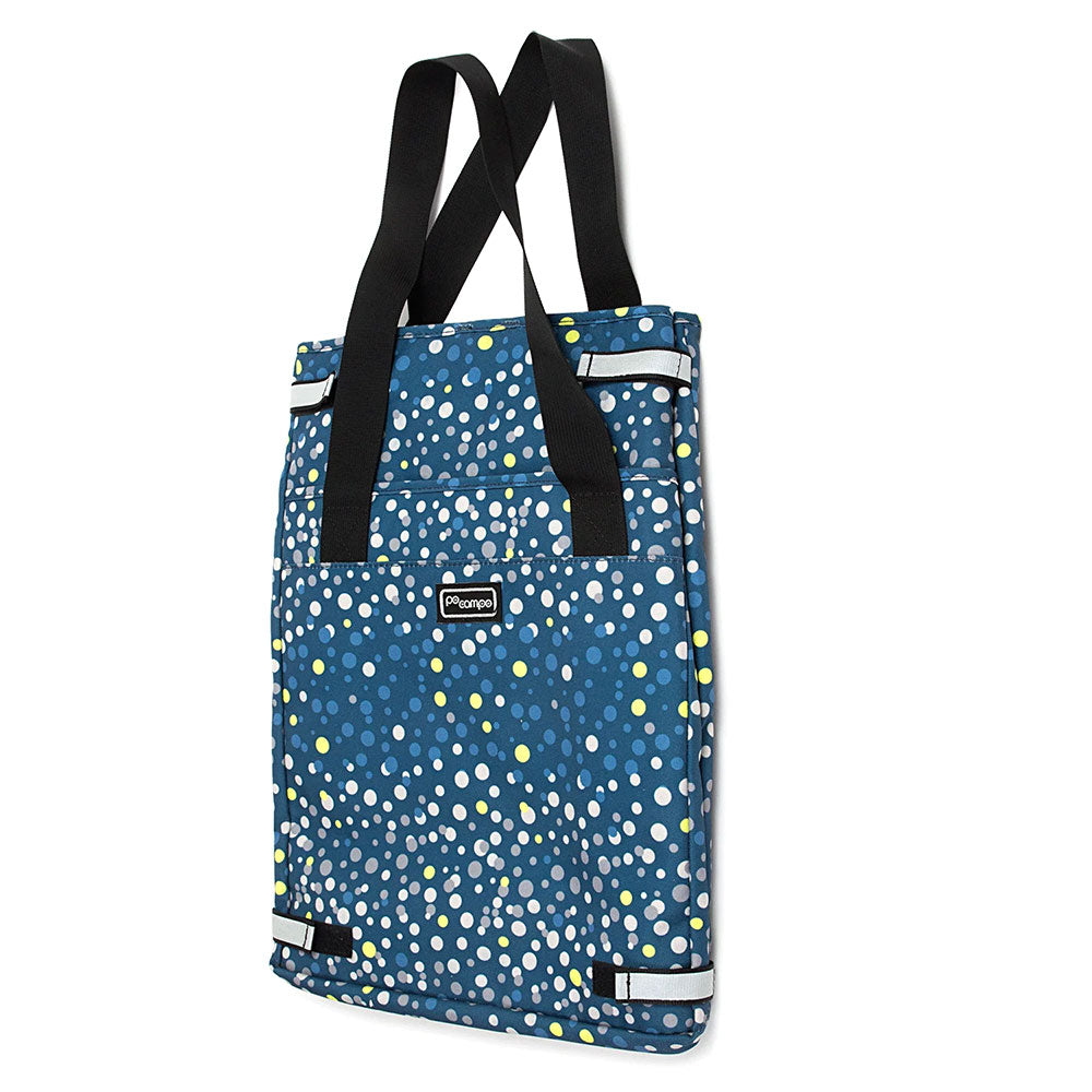 Blue grocery bag with black straps and a pattern of white and yellow dots on a white background