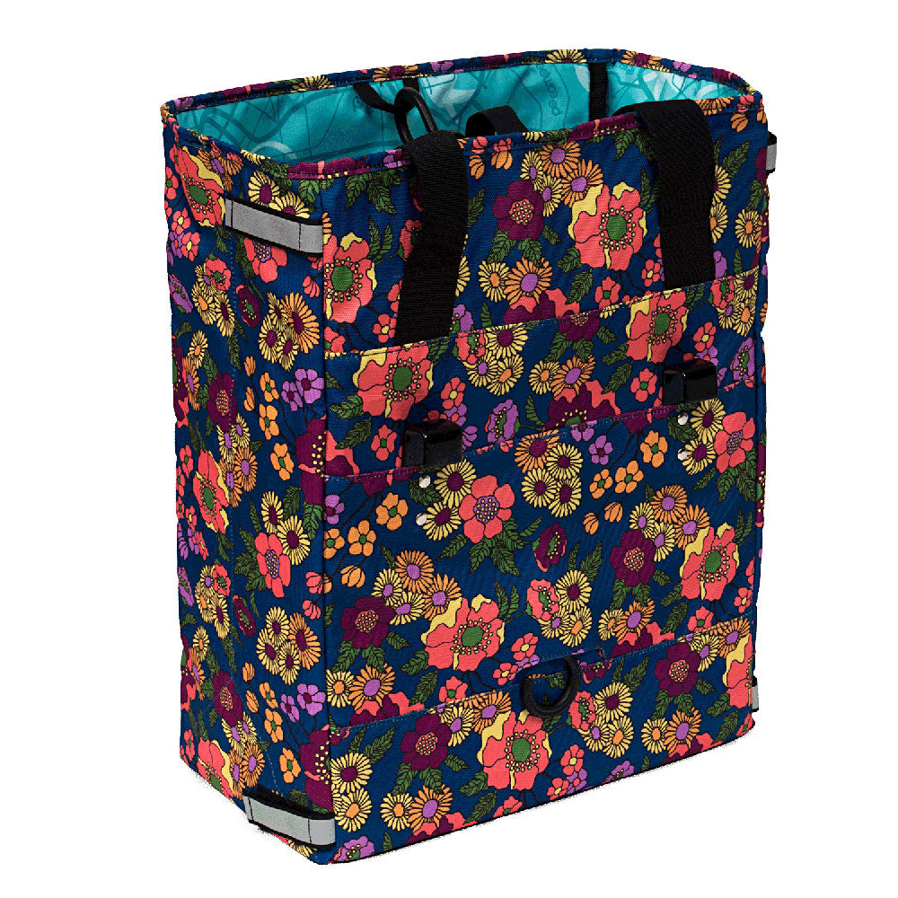 Floral-patterned Po Campo grocery pannier with black handles on a white background