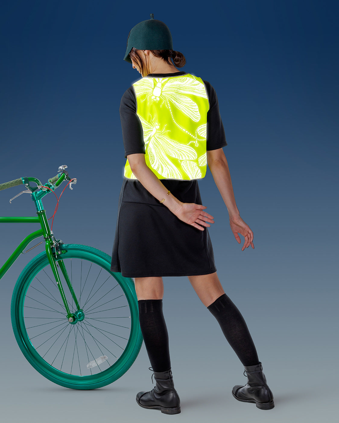 Hi-vis reflective vest with dragonfly pattern and electric green bicycle.