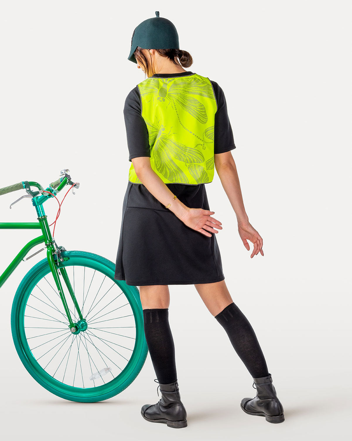Hi-vis reflective vest with dragonfly pattern and electric green bicycle.