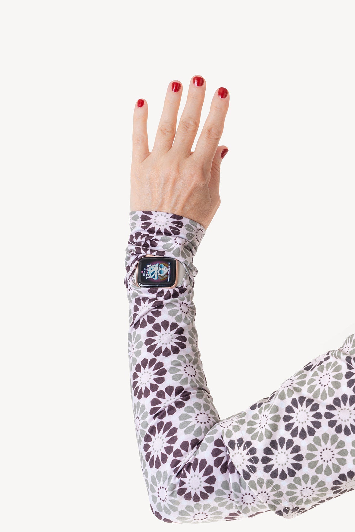Hand wearing a patterned arm sleeve on a white background