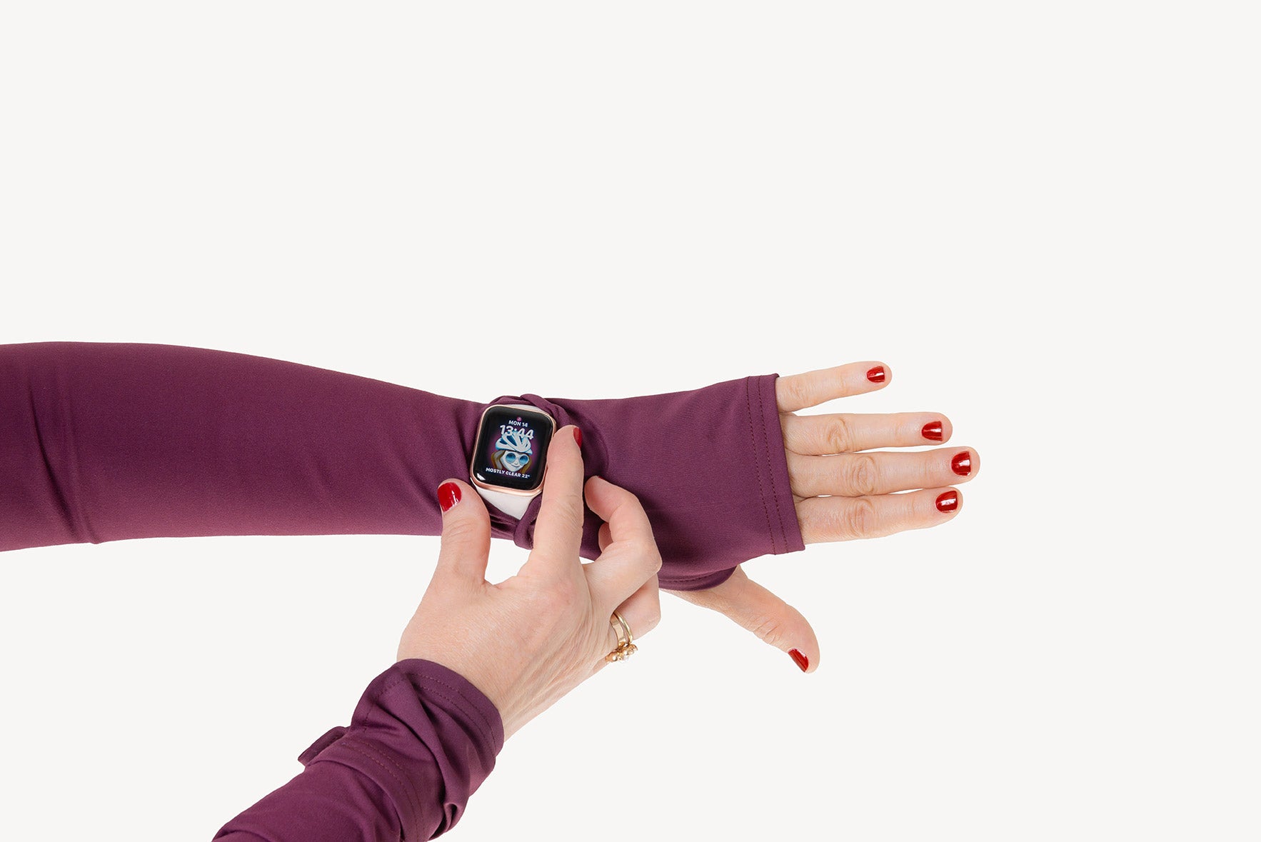 Person wearing a smartwatch with a matching purple arm sleeve on a white background