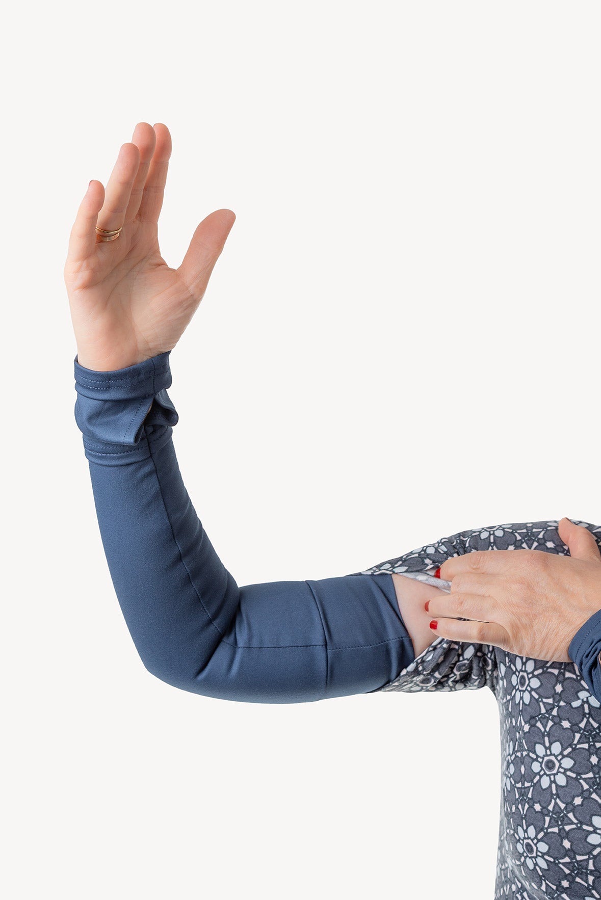 Person wearing a blue arm warmer with a white background