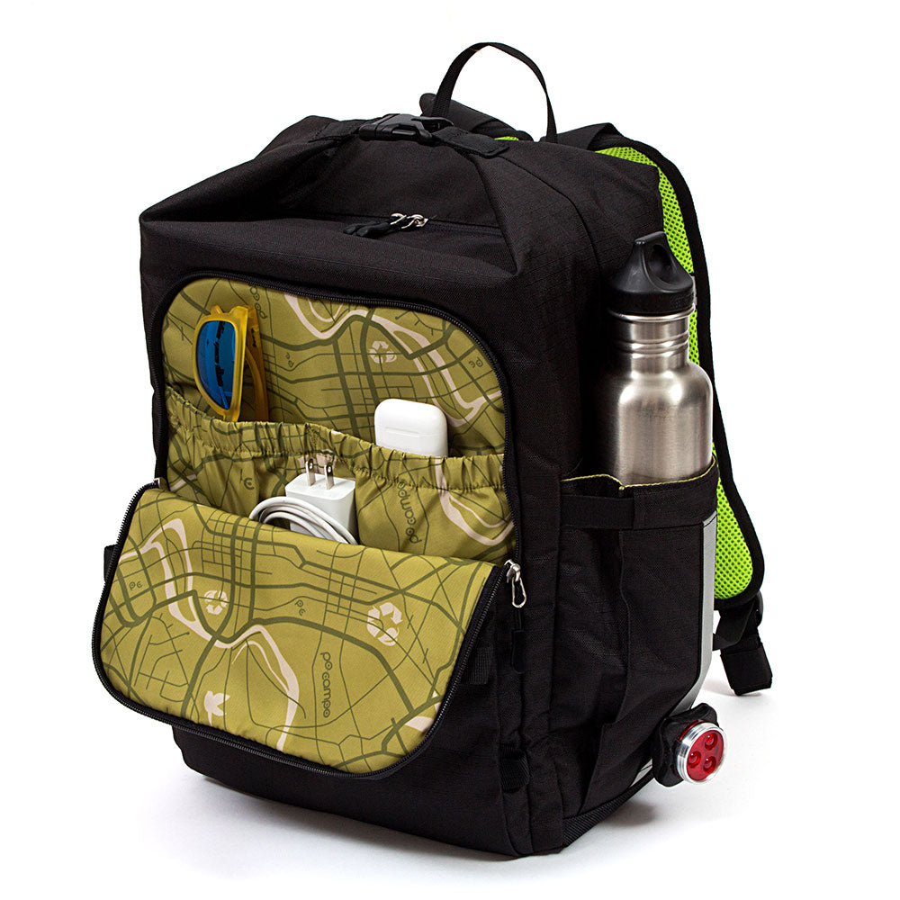 Black Bedford backpack with green map design pocket, water bottle, and electronic devices on a white background