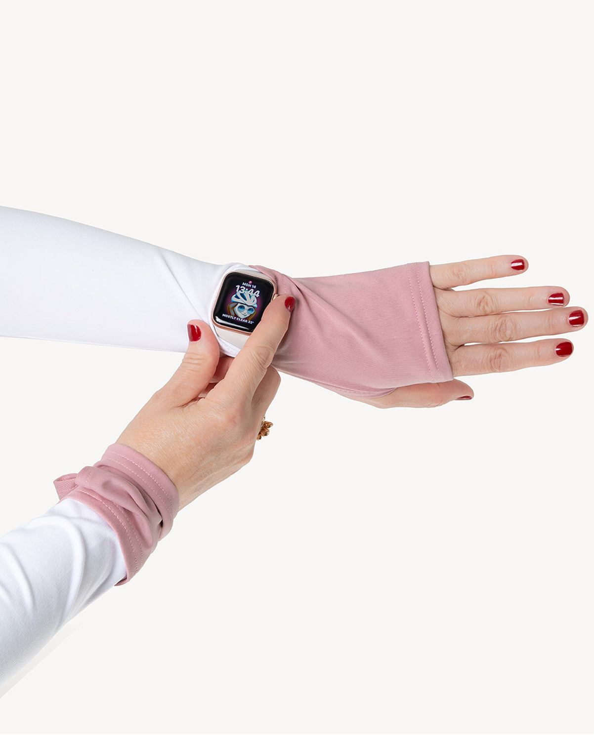 Person wearing a white and pink arm warmer with a smartwatch on a white background