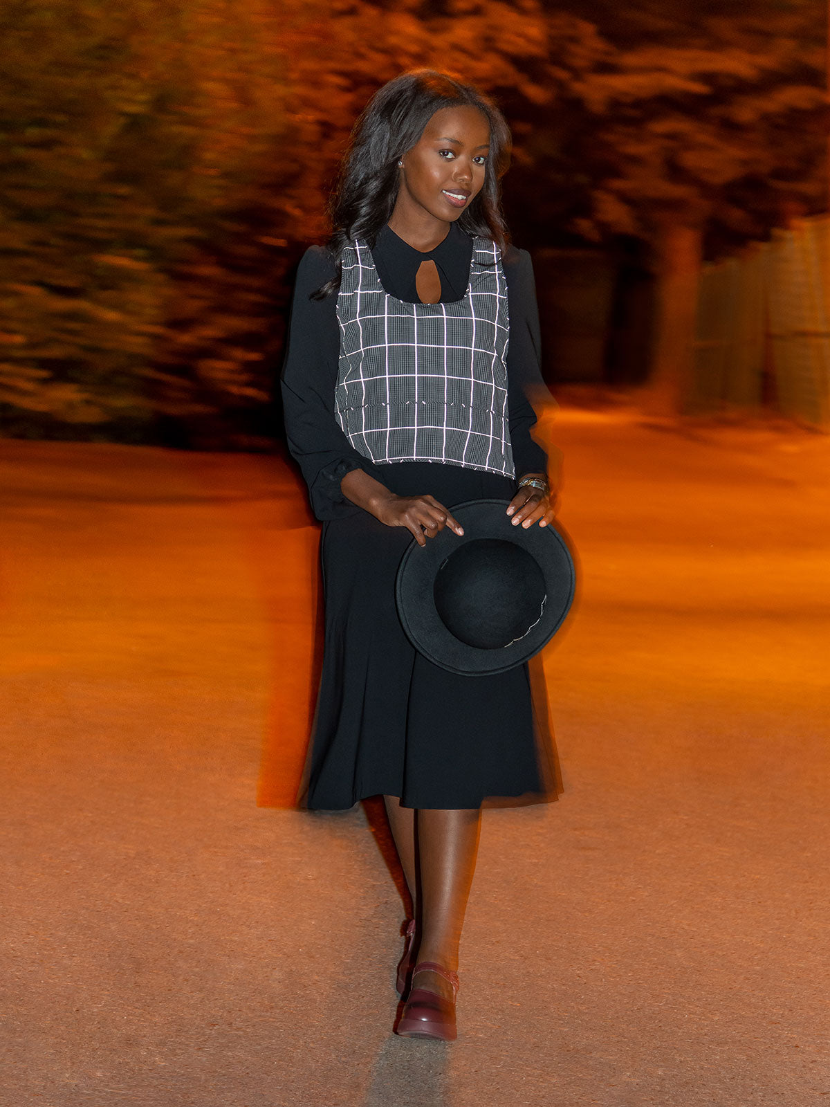 Night photo of woman wearing reversible high vis reflective vest showing reflective threads