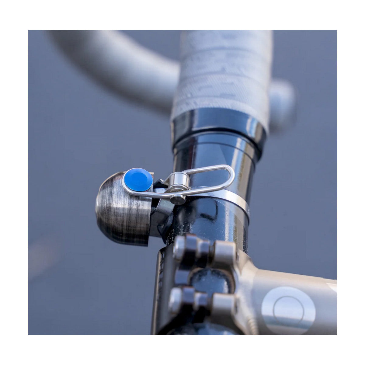 Close-up of a bicycle handlebar with a blue bell attached