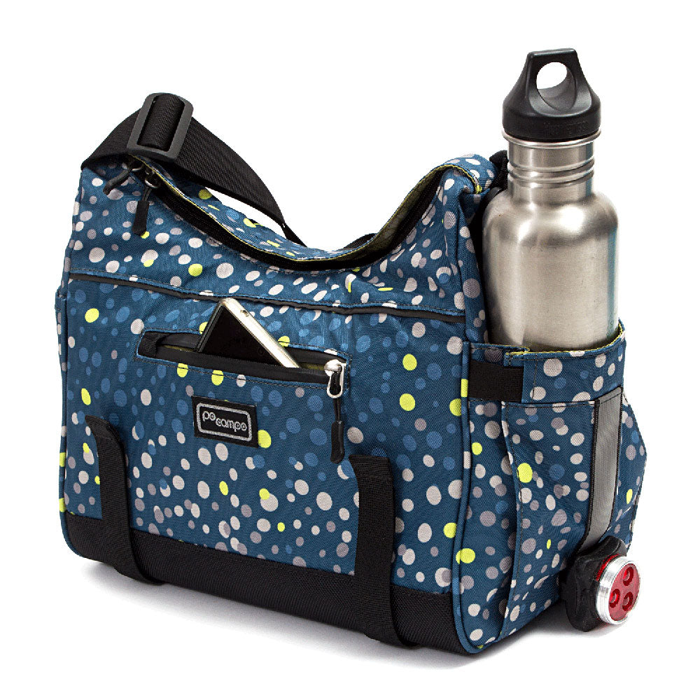 Blue polka dot trunk bag with a water bottle and phone inside on a white background