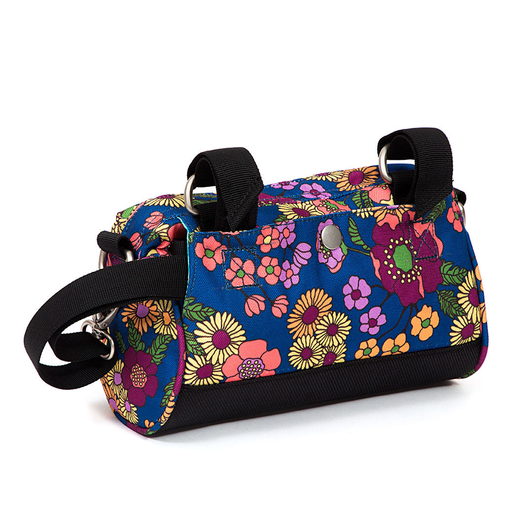 Colorful floral-patterned handlebar bag with black straps on a white background