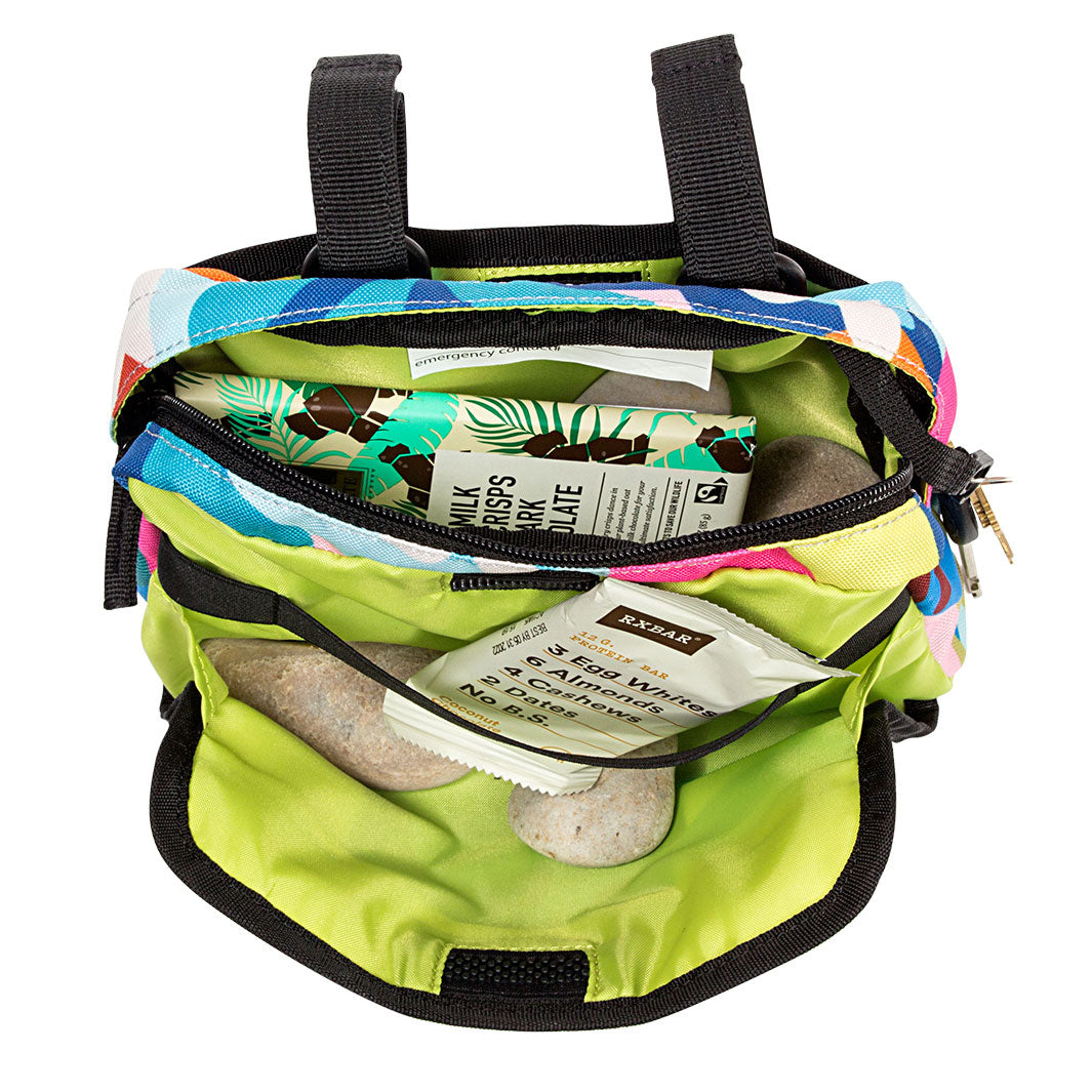 Colorful handlebar bag with items inside on a white background