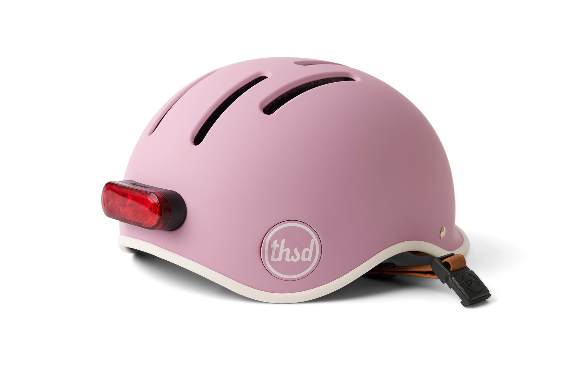 Pink helmet with a red light on a white background