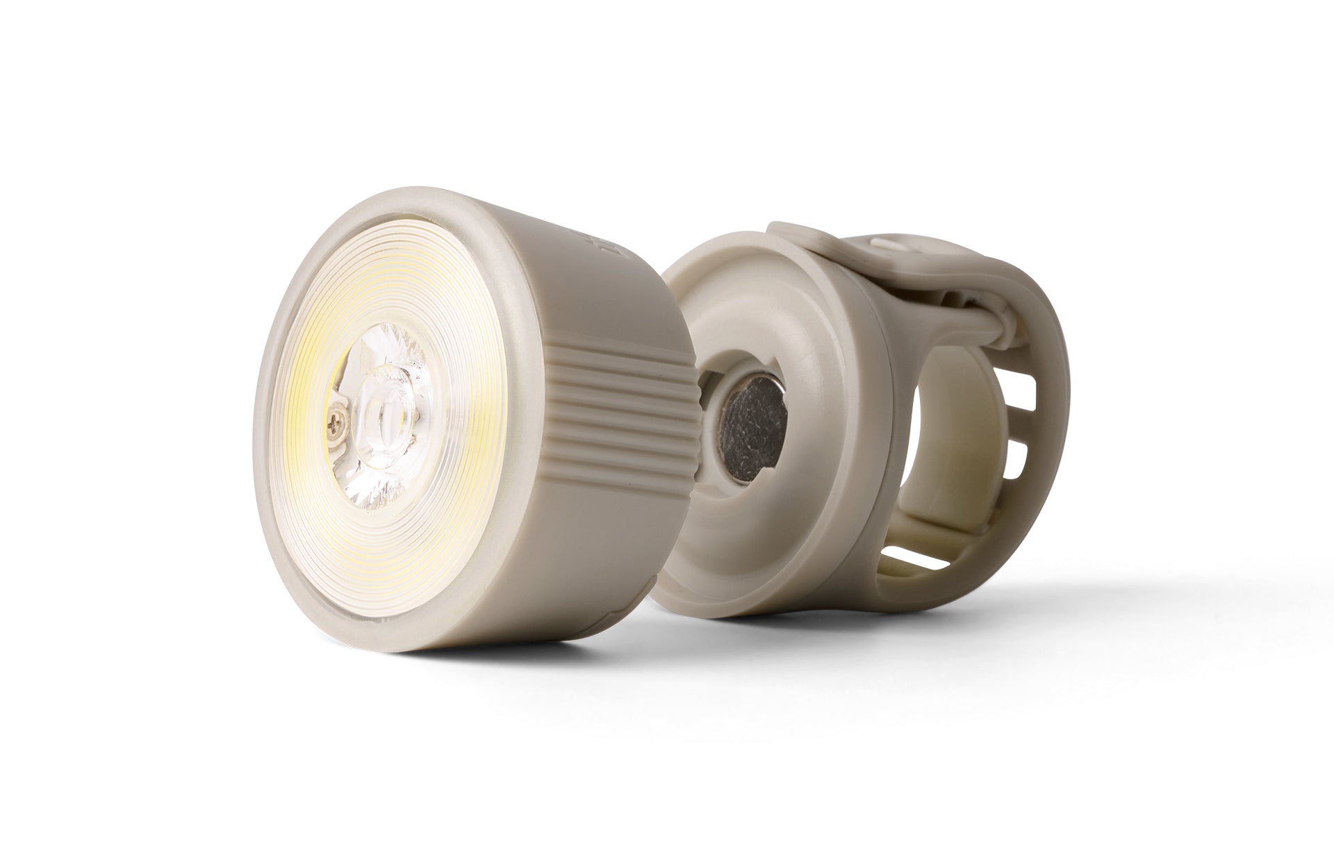 Detachable, rechargeable front bicycle light on white background.