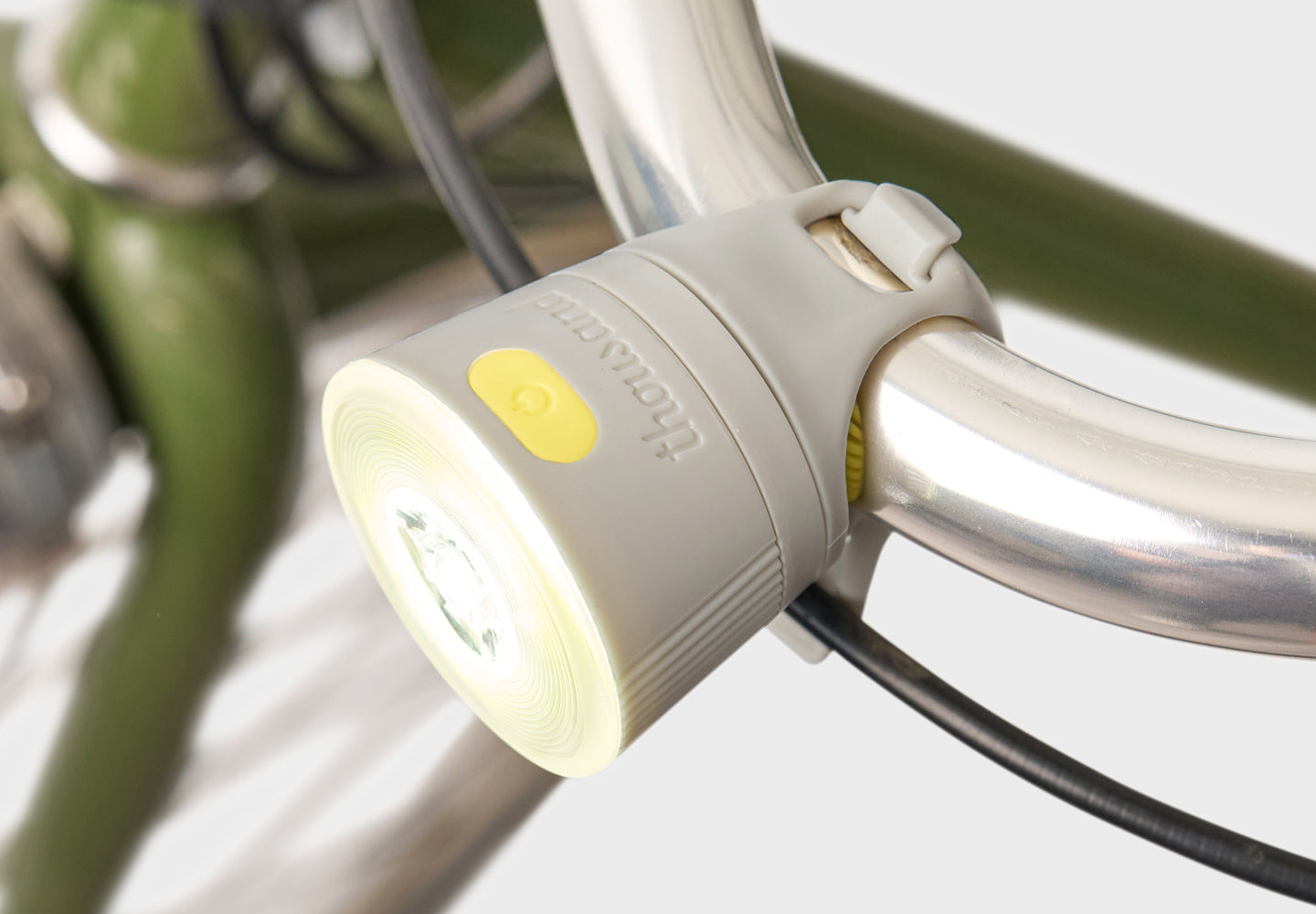 Bicycle front light attached to a bike frame with a blurred background