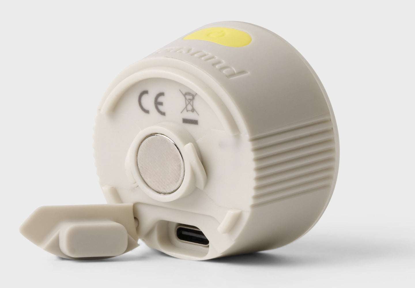 White electronic bicycle light with a USB port on a light gray background
