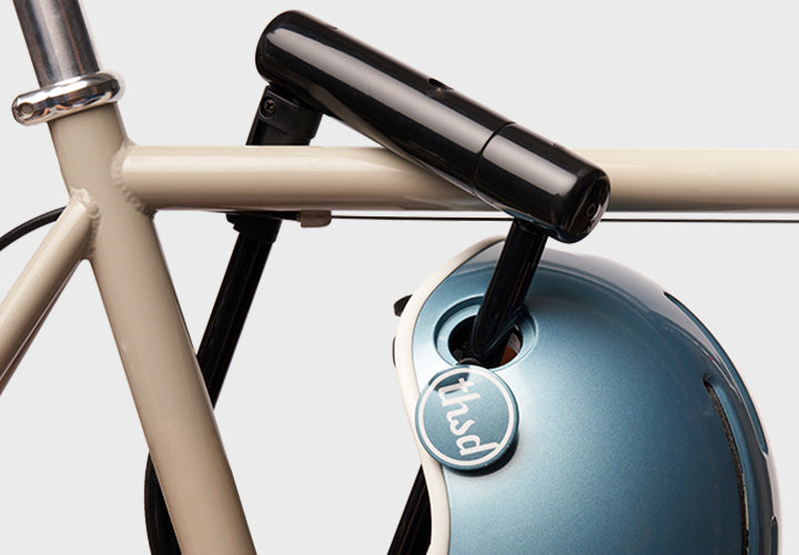Close-up of a bicycle helmet with a bike lock on a white background