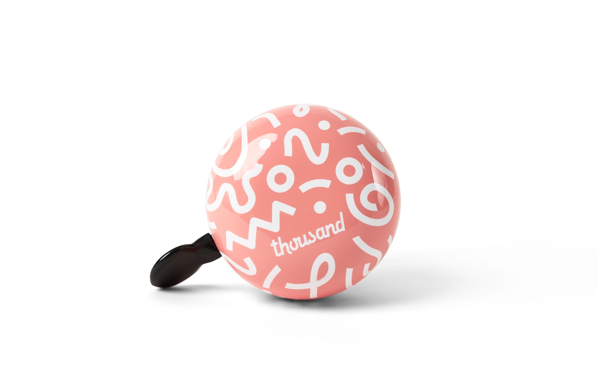 Pink bicycle bell with white patterns on a white background