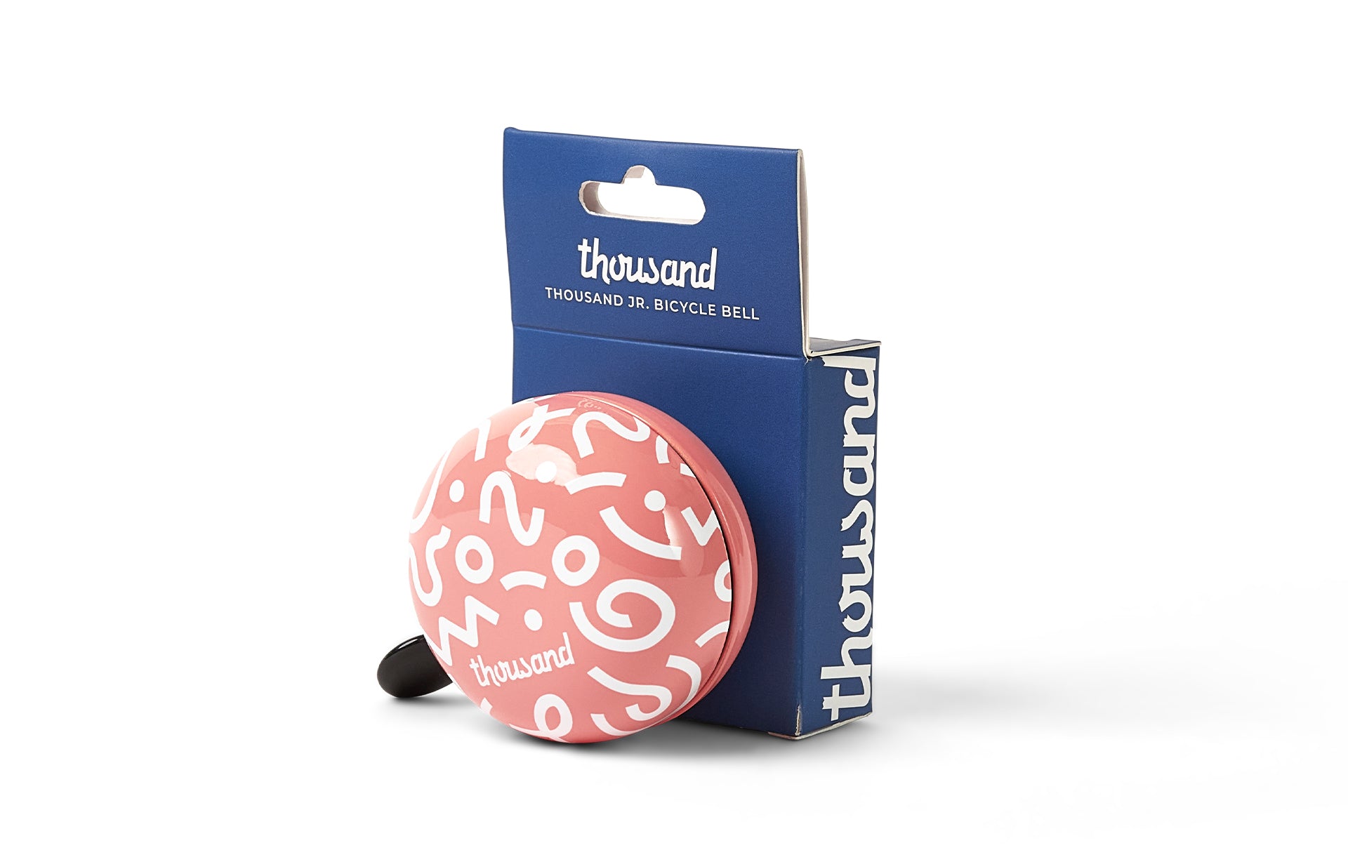 Pink bicycle bell with white patterns and packaging on a white background