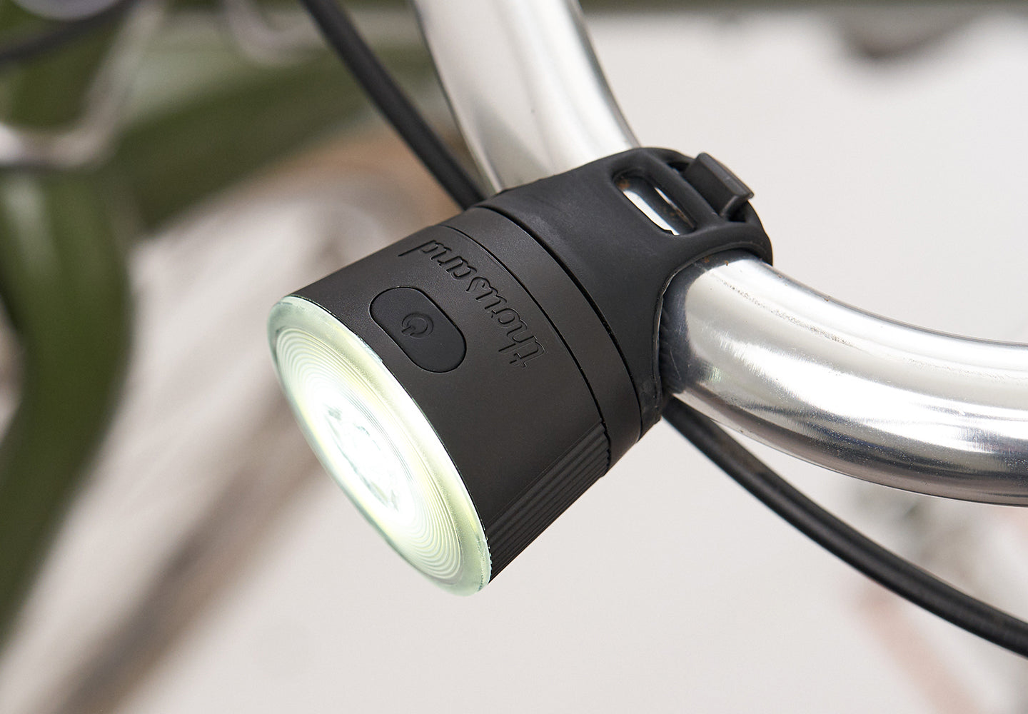 Bicycle light attached to a bike handlebar.