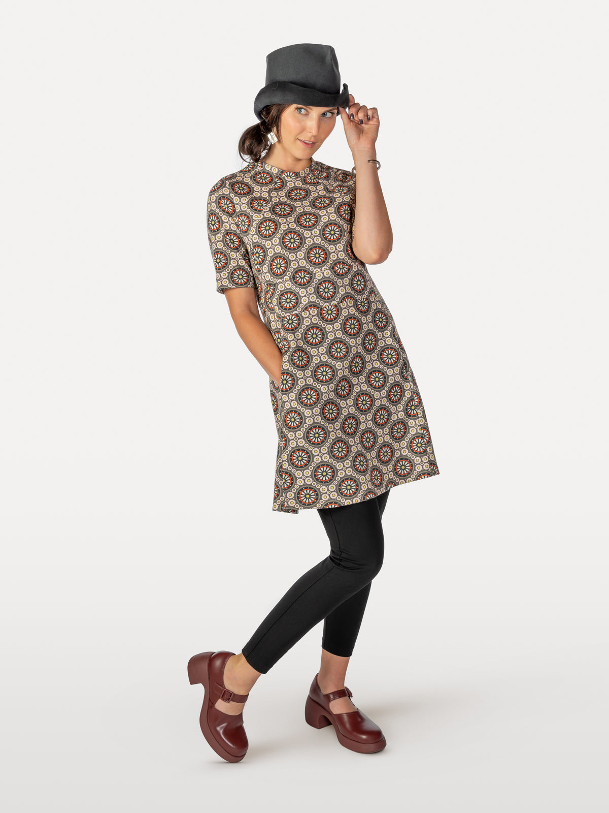 Bicycle-spoke patterned cycling dress red, pink and taupe over leggings